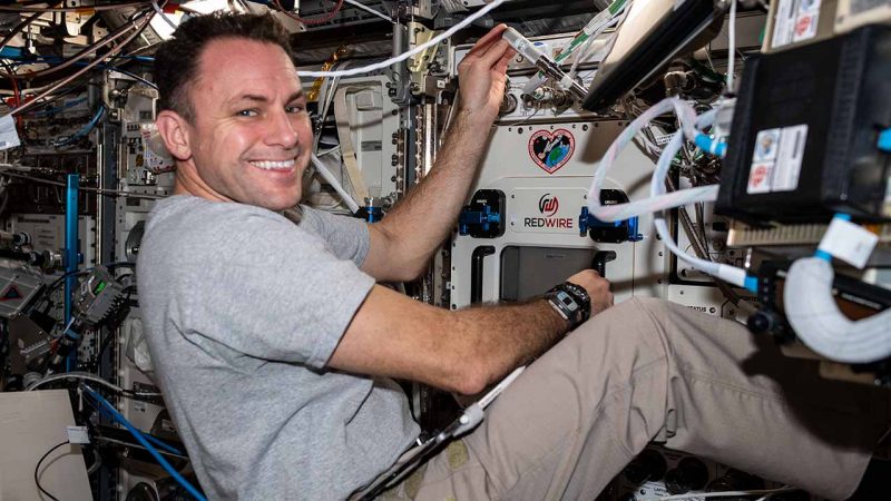 Caption: NASA astronaut Josh Cassada installs Redwire's 3D BioFabrication Facility on the ISS. (Credit: NASA)