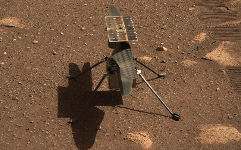 Caption: NASA’s Ingenuity helicopter on the surface of Mars, as seen in an image taken by the Perseverance Rover. (Credit: NASA)