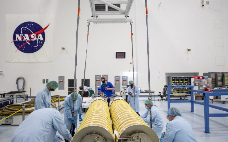NASA and Boeing workers move solar arrays for the International Space Station to flight support equipment in the high bay of the Space Station Processing Facility at NASA’s Kennedy Space Center in Florida on April 2, 2021. The 63- by- 20-foot solar arrays will launch to the International Space Station later this year. They are the first two of six new solar arrays that in total will produce more than 120 kilowatts of electricity from the Sun’s energy, enough to power more than 40 average U.S. homes. Combined with the eight original, larger arrays, this advanced hardware will provide 215 kilowatts of energy, a 20 to 30 percent increase in power, helping maximize the space station’s capabilities for years to come. The arrays will produce electricity to sustain the station’s systems and equipment, plus augment the electricity available to continue a wide variety of public and private experiments and research in the microgravity environment of low-Earth orbit.