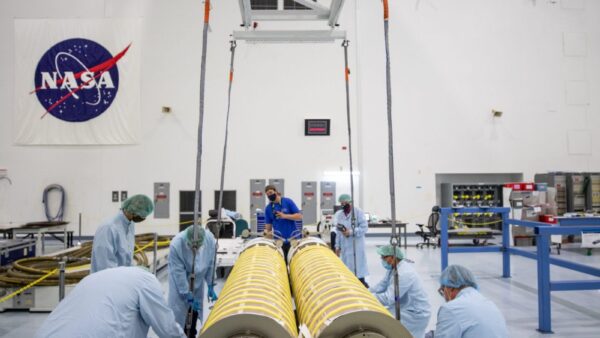 NASA and Boeing workers move solar arrays for the International Space Station to flight support equipment in the high bay of the Space Station Processing Facility at NASA’s Kennedy Space Center in Florida on April 2, 2021. The 63- by- 20-foot solar arrays will launch to the International Space Station later this year. They are the first two of six new solar arrays that in total will produce more than 120 kilowatts of electricity from the Sun’s energy, enough to power more than 40 average U.S. homes. Combined with the eight original, larger arrays, this advanced hardware will provide 215 kilowatts of energy, a 20 to 30 percent increase in power, helping maximize the space station’s capabilities for years to come. The arrays will produce electricity to sustain the station’s systems and equipment, plus augment the electricity available to continue a wide variety of public and private experiments and research in the microgravity environment of low-Earth orbit.